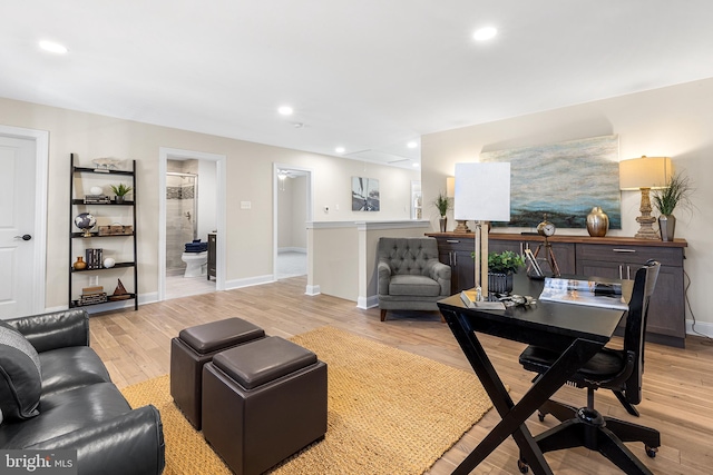 living room with light wood-type flooring, baseboards, and recessed lighting