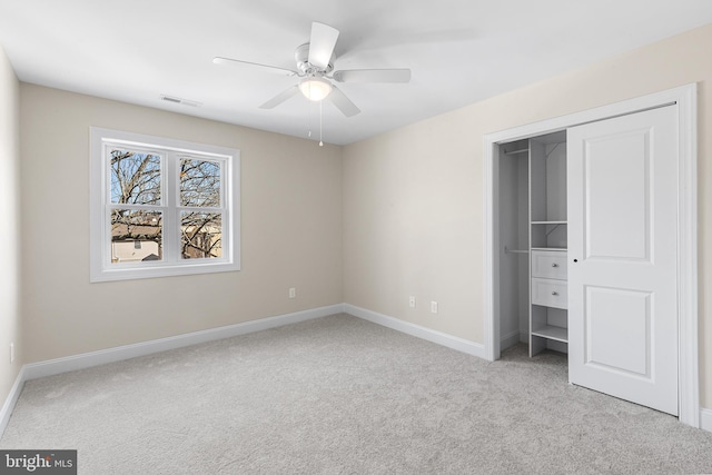 unfurnished bedroom featuring baseboards, a closet, visible vents, and carpet flooring