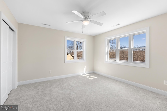 unfurnished bedroom featuring carpet floors, visible vents, and baseboards