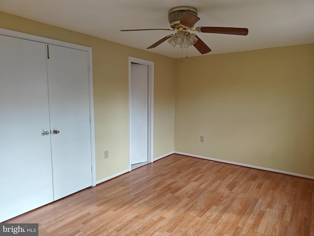 unfurnished bedroom featuring light wood-type flooring, ceiling fan, and baseboards