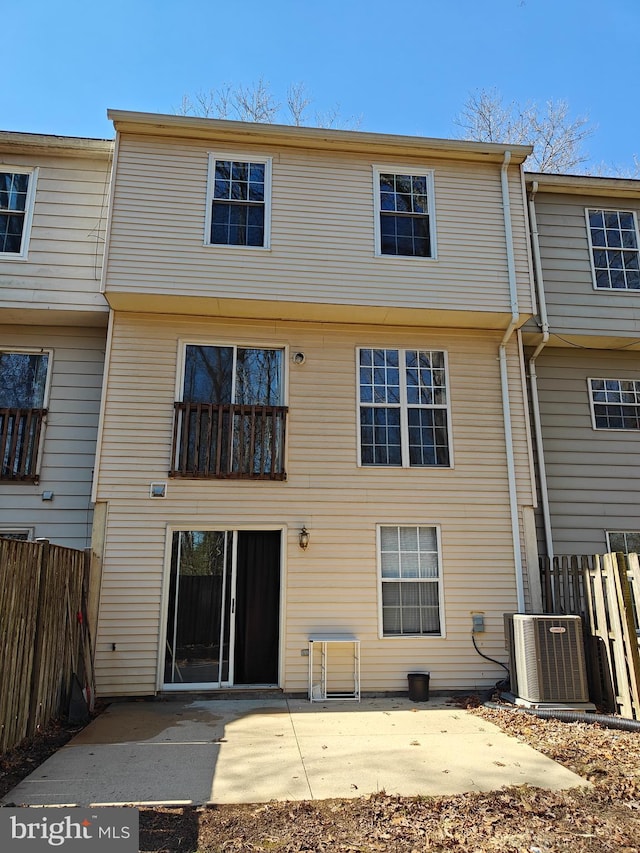 back of property with central AC, a patio, and fence