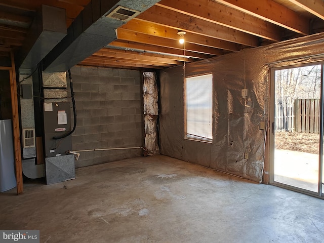 below grade area featuring visible vents and water heater