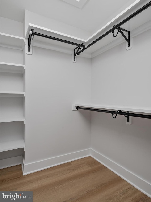 spacious closet with wood finished floors