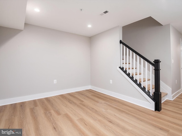 interior space with wood finished floors, visible vents, and baseboards