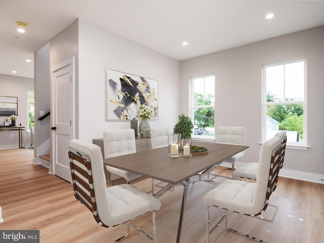 dining room with light wood-type flooring and recessed lighting