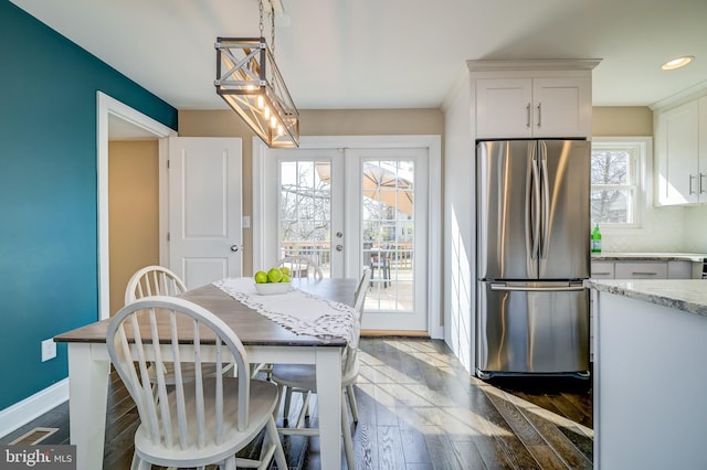 dining space featuring a wealth of natural light, french doors, baseboards, and wood finished floors