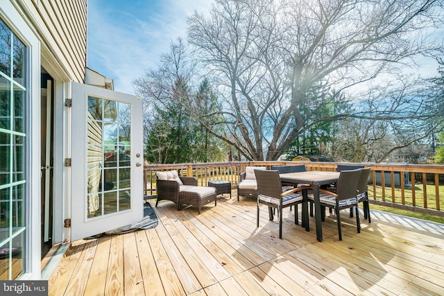 wooden terrace featuring outdoor dining area