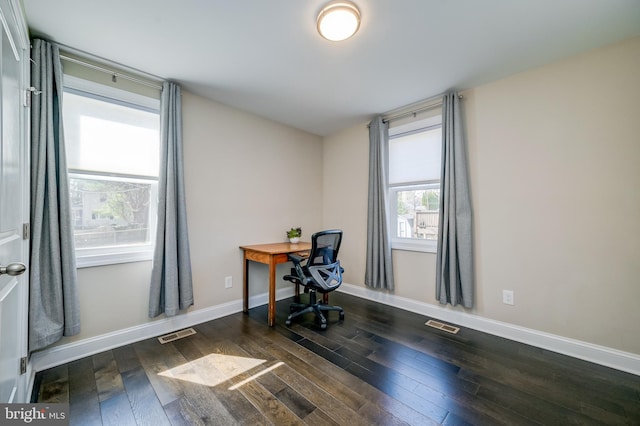 office featuring visible vents, baseboards, and wood finished floors