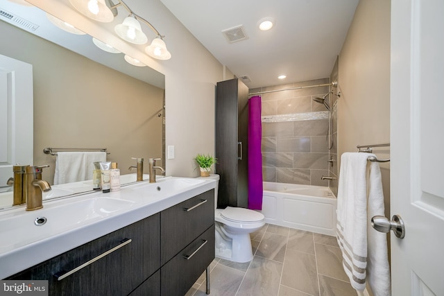 bathroom featuring visible vents, toilet, and a sink