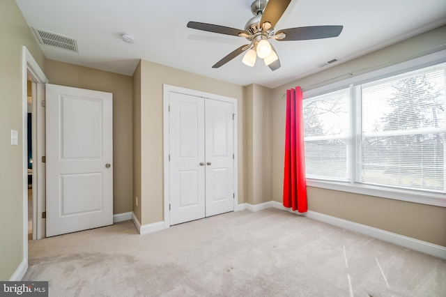 unfurnished bedroom with a ceiling fan, baseboards, visible vents, a closet, and carpet flooring