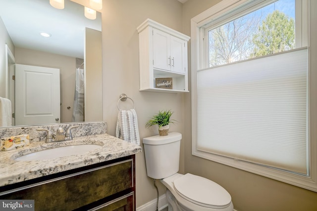 bathroom with toilet and vanity