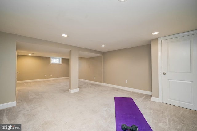 exercise area featuring recessed lighting, light colored carpet, and baseboards