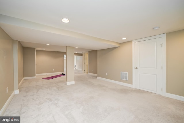 finished below grade area featuring recessed lighting, light colored carpet, visible vents, and baseboards