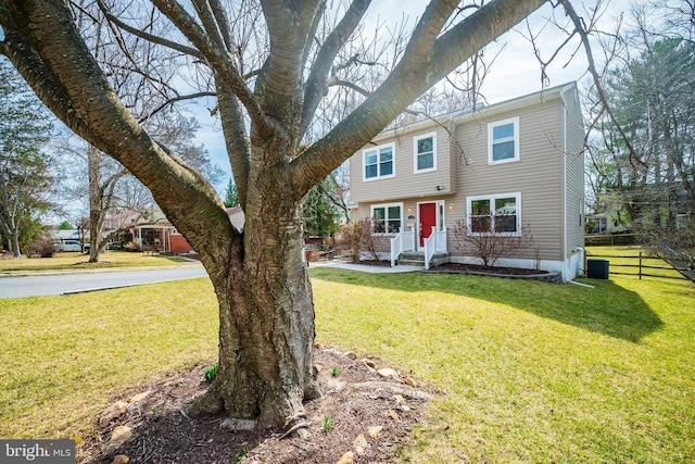 colonial-style house with a front lawn