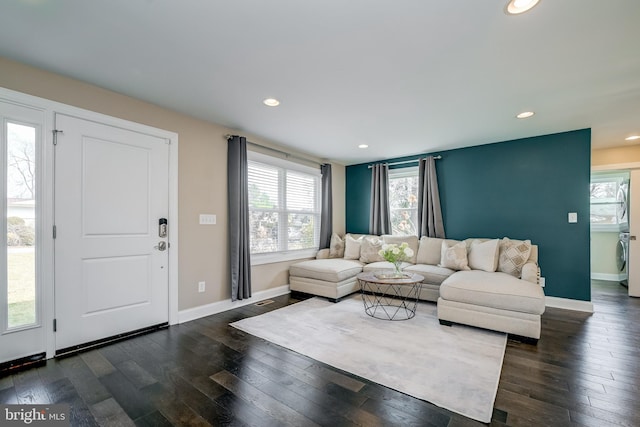 living room with washer / dryer, recessed lighting, dark wood-type flooring, and baseboards