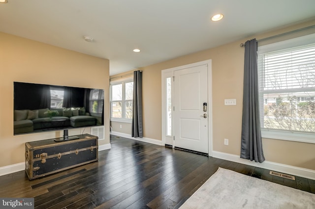 foyer with recessed lighting, visible vents, baseboards, and dark wood-style flooring