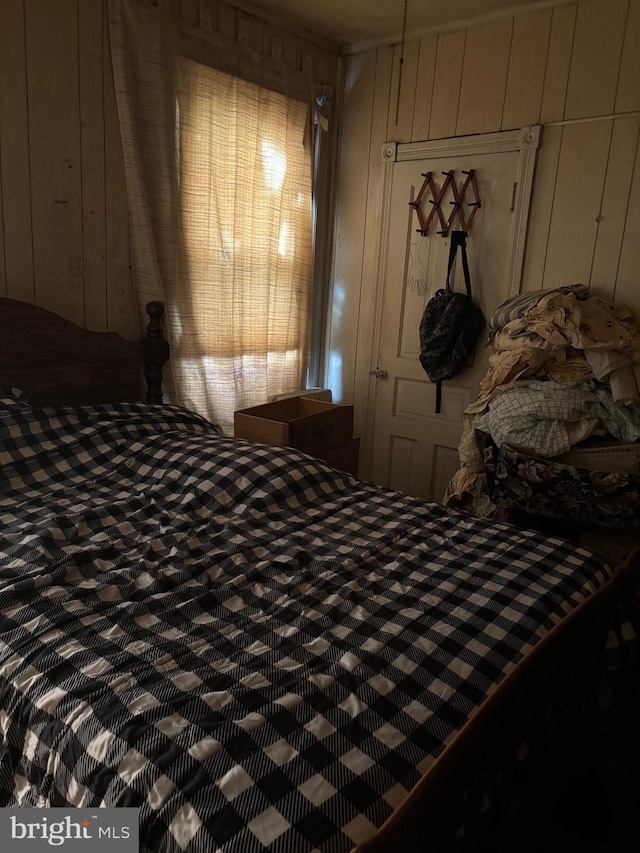 bedroom featuring wood walls