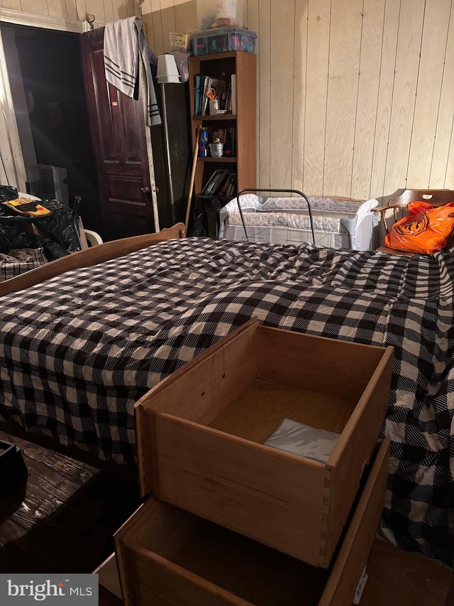 bedroom with wood walls