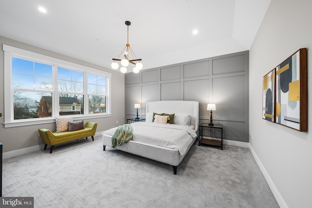 bedroom with carpet, a decorative wall, baseboards, and an inviting chandelier