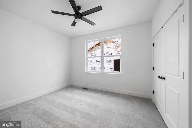 unfurnished bedroom with carpet floors, a closet, ceiling fan, and baseboards