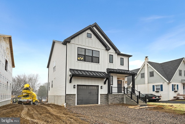 modern inspired farmhouse with a garage, metal roof, a standing seam roof, and board and batten siding