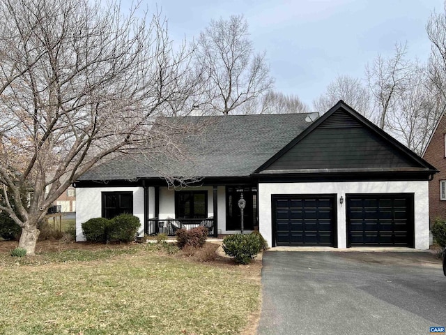 ranch-style house featuring a garage, a porch, aphalt driveway, roof with shingles, and a front lawn