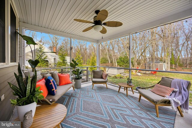 sunroom / solarium featuring wooden ceiling and ceiling fan