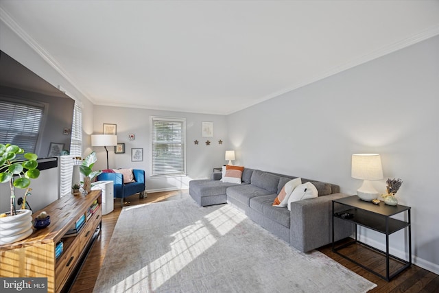 living room with ornamental molding, baseboards, and wood finished floors