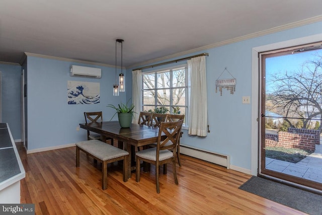 dining area featuring a wall mounted air conditioner, a baseboard radiator, light wood-style flooring, and crown molding