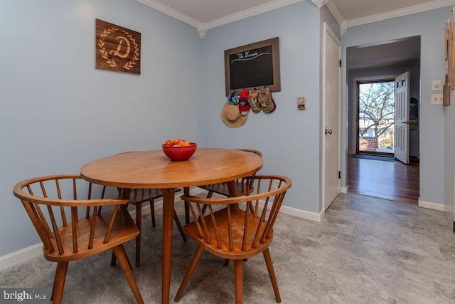 dining room with baseboards and crown molding