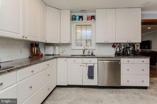 kitchen with dark stone countertops, a sink, decorative backsplash, white cabinets, and dishwasher