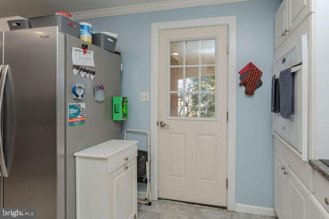 interior space with baseboards and crown molding