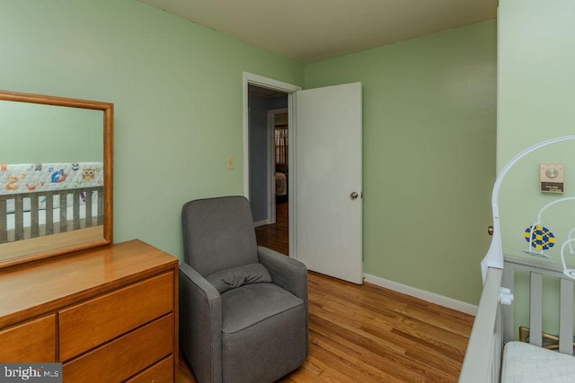 bedroom featuring light wood-type flooring and baseboards