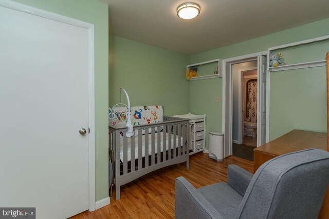 bedroom featuring wood finished floors and baseboards