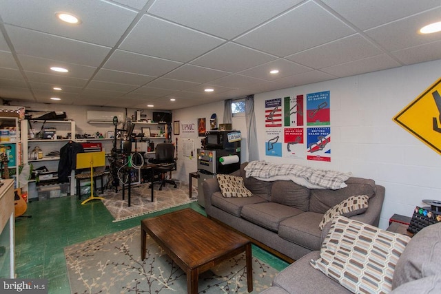 living room featuring tile patterned floors, a drop ceiling, recessed lighting, and concrete block wall