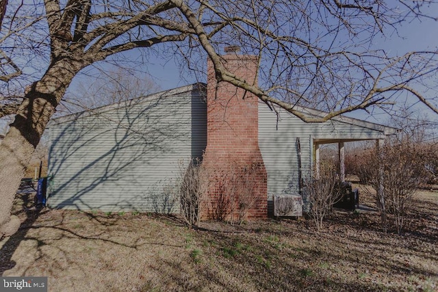 view of property exterior featuring a chimney