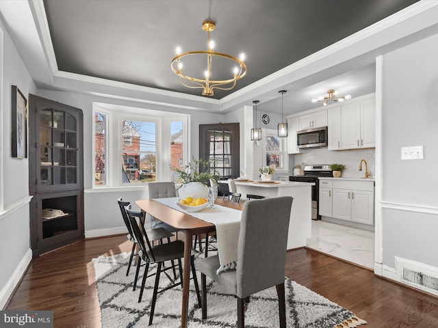 dining space featuring visible vents, baseboards, dark wood finished floors, a raised ceiling, and a notable chandelier