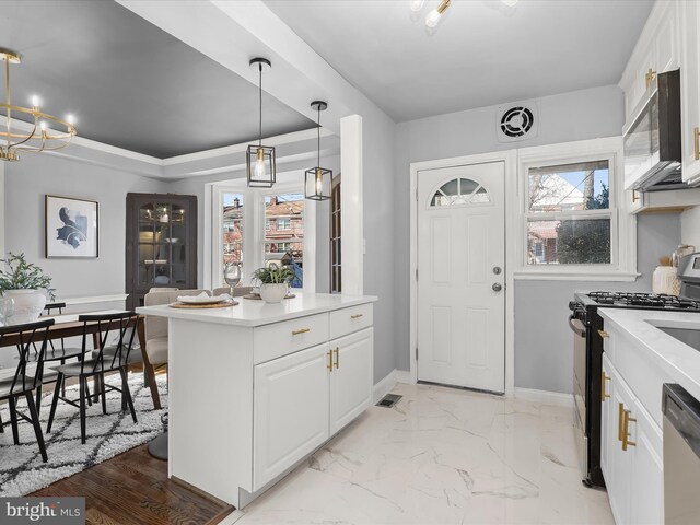 kitchen featuring stainless steel appliances, baseboards, light countertops, and white cabinetry