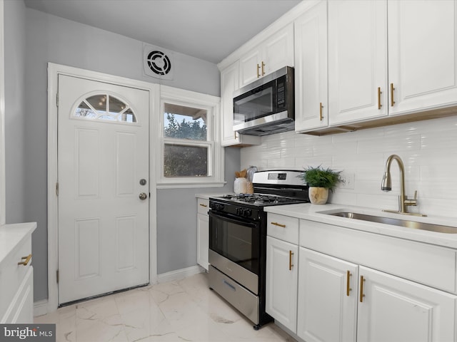 kitchen featuring range with gas stovetop, visible vents, a sink, stainless steel microwave, and marble finish floor