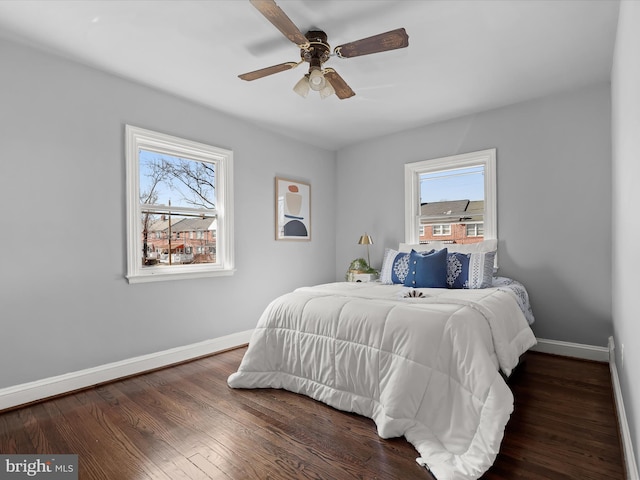 bedroom with baseboards, wood finished floors, and a ceiling fan