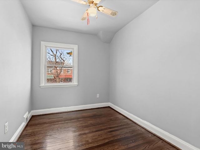 unfurnished room featuring baseboards, dark wood-type flooring, lofted ceiling, and a ceiling fan