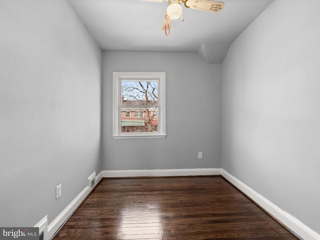 unfurnished room featuring visible vents, a ceiling fan, baseboards, and wood finished floors