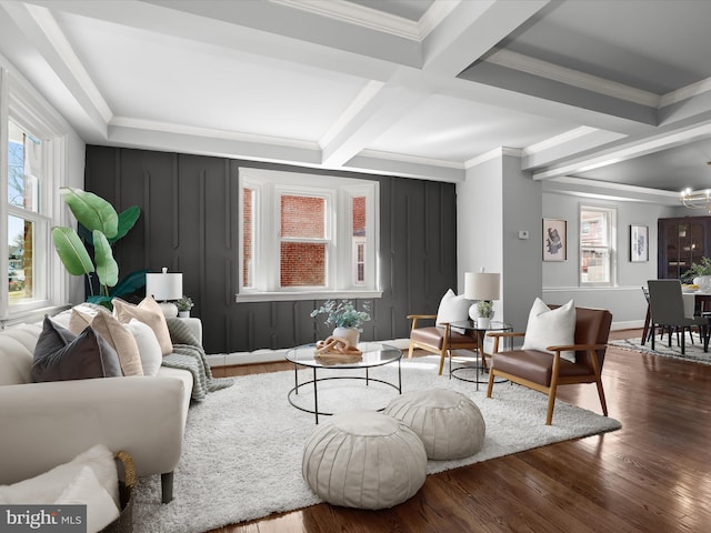 living room with beamed ceiling, coffered ceiling, crown molding, and wood finished floors