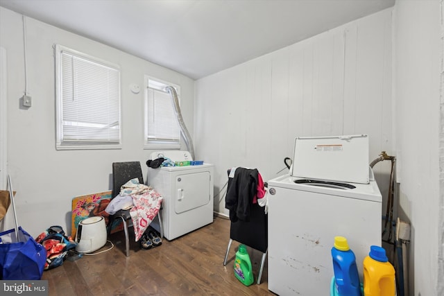 washroom featuring laundry area, wood finished floors, and washer and dryer