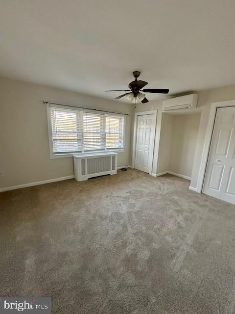 unfurnished bedroom featuring carpet flooring, baseboards, a wall mounted AC, radiator heating unit, and two closets