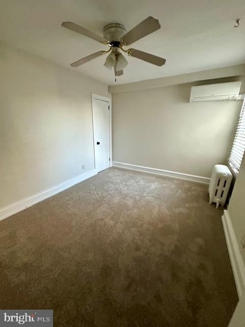 unfurnished bedroom with ceiling fan, baseboards, carpet flooring, and a wall mounted air conditioner