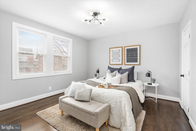 bedroom featuring dark wood-style floors and baseboards