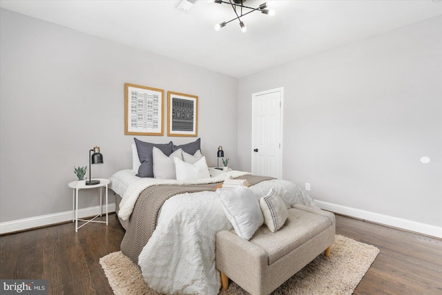 bedroom with wood finished floors and baseboards