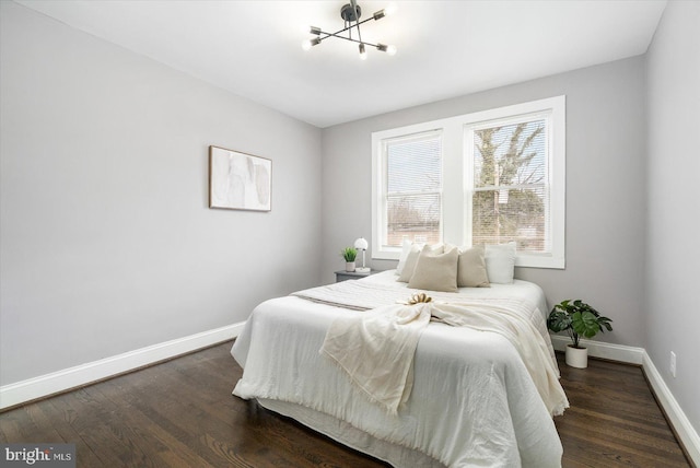 bedroom with baseboards and dark wood-style flooring