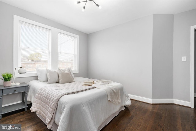 bedroom featuring wood finished floors and baseboards